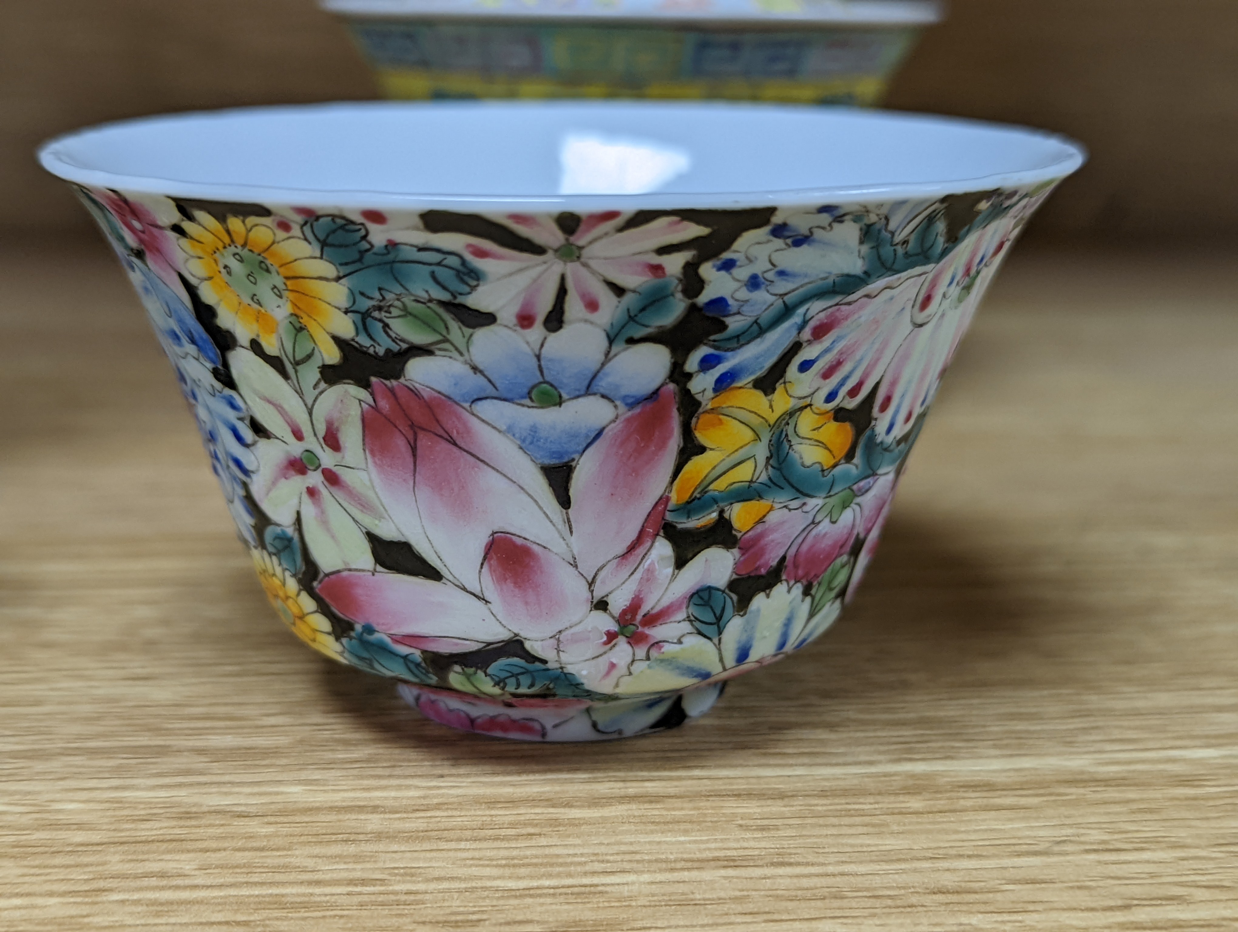 A pair of Chinese enamelled porcelain rice bowls, covers and stands and an odd bowl